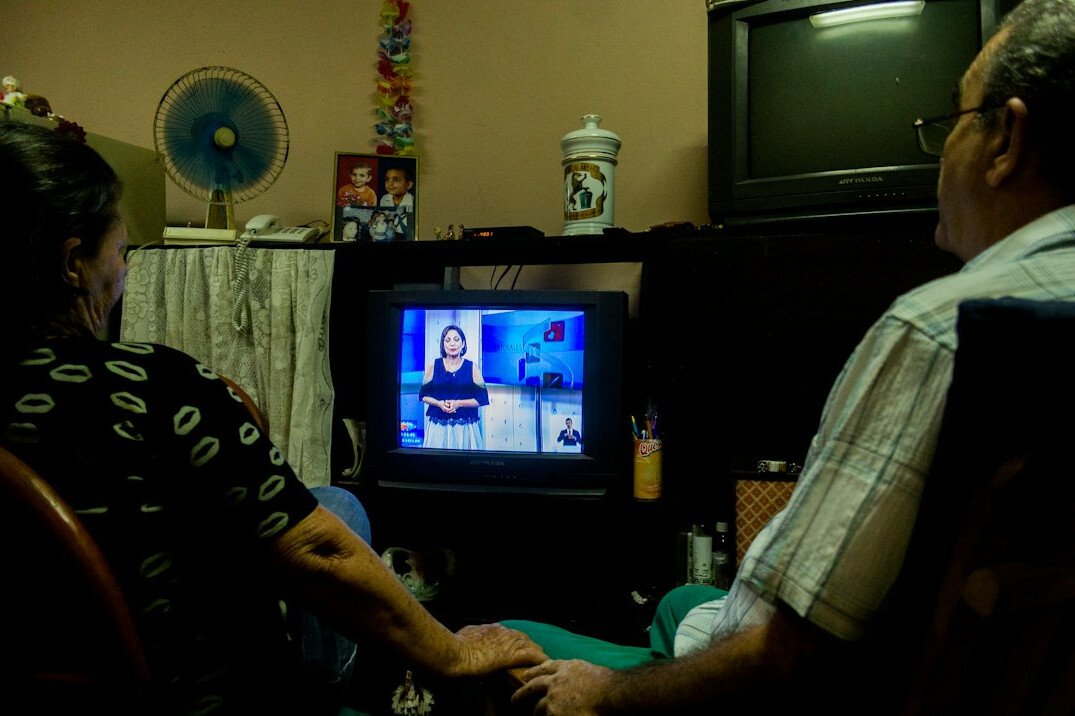 group watching old tv